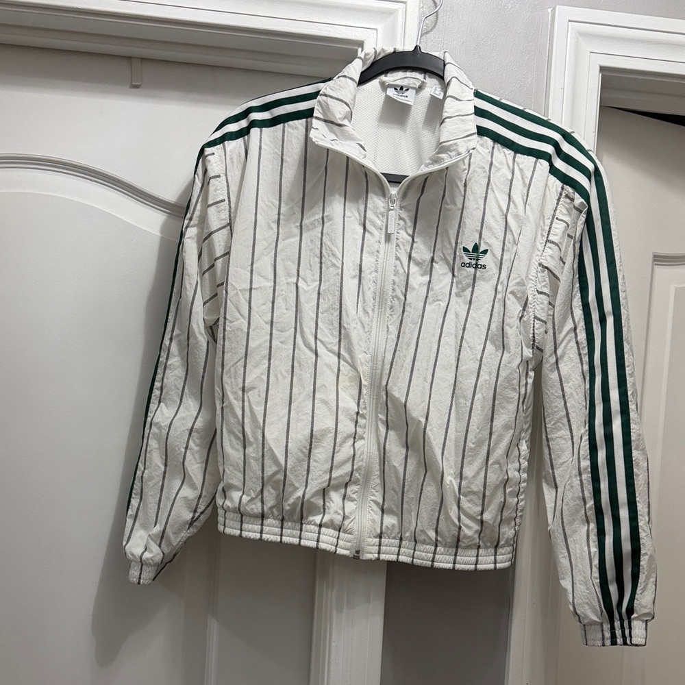 Adidas White Jacket with Green Stripes has a small stain barely see it wind brea